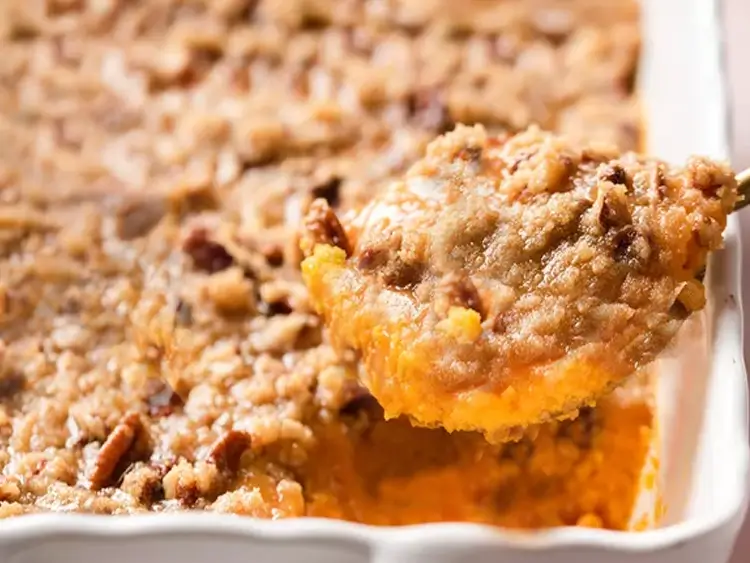 Sweet potato casserole with pecan topping in a baking dish