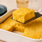 Creamy baked corn casserole served in a white baking dish