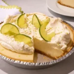 Creamy homemade key lime pie with whipped cream and lime slices