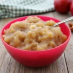 Bowl of homemade applesauce garnished with cinnamon.
