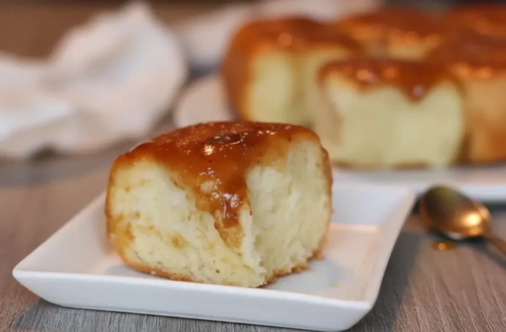 Best caramel rolls — golden rolls drenched in sticky brown sugar caramel in a baking pan.