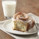Classic cinnamon rolls topped with creamy icing, golden and fluffy.