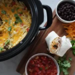 Open breakfast burrito stuffed with cheesy egg, hash brown and turkey sausage filling.