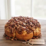 Fresh homemade sticky buns with caramelized pecans and raisins on top.