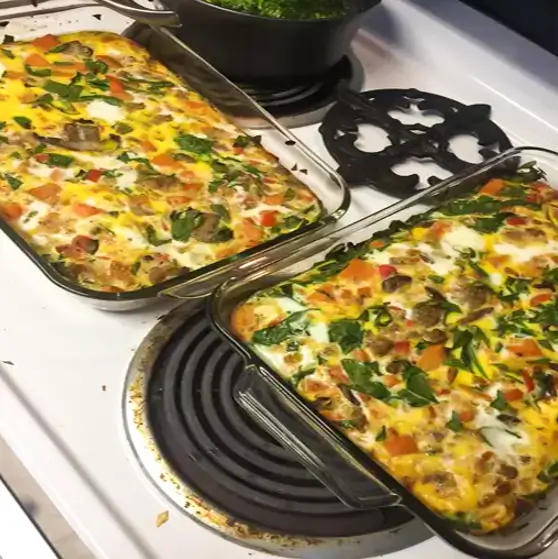 Sweet potato breakfast bake with turkey sausage, kale and mushrooms, garnished with green onion.