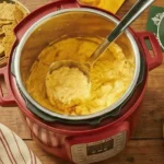 Bowl of Healthier Buffalo Chicken Dip with celery sticks and multigrain crackers