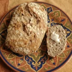 Golden Oatmeal Whole Wheat Quick Bread sliced on a wooden board